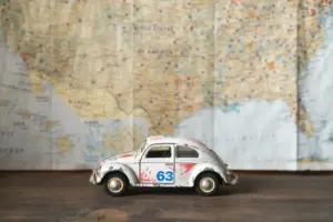 A toy car on a map, the road-trip planning mood of a travel blog