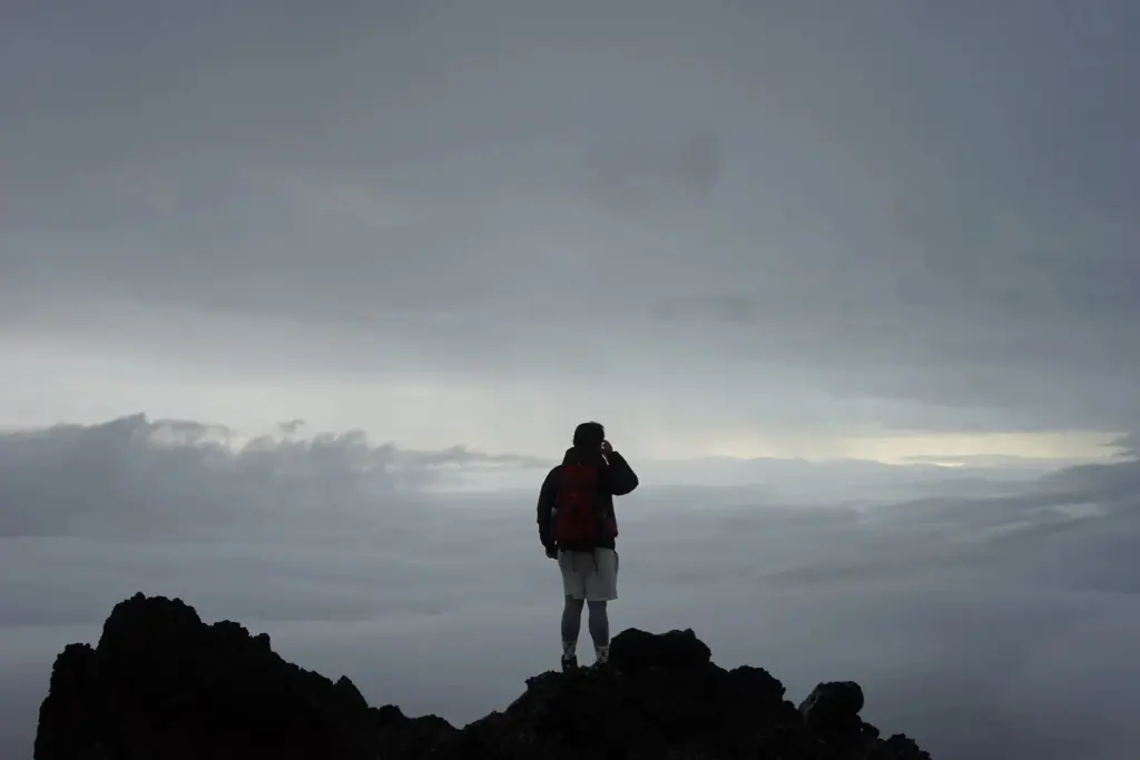 An adventurer looking out at mountains, the spirit of exploration in the site name